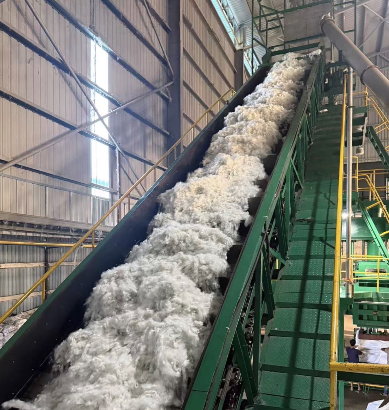 Recycled fiber on a conveyor